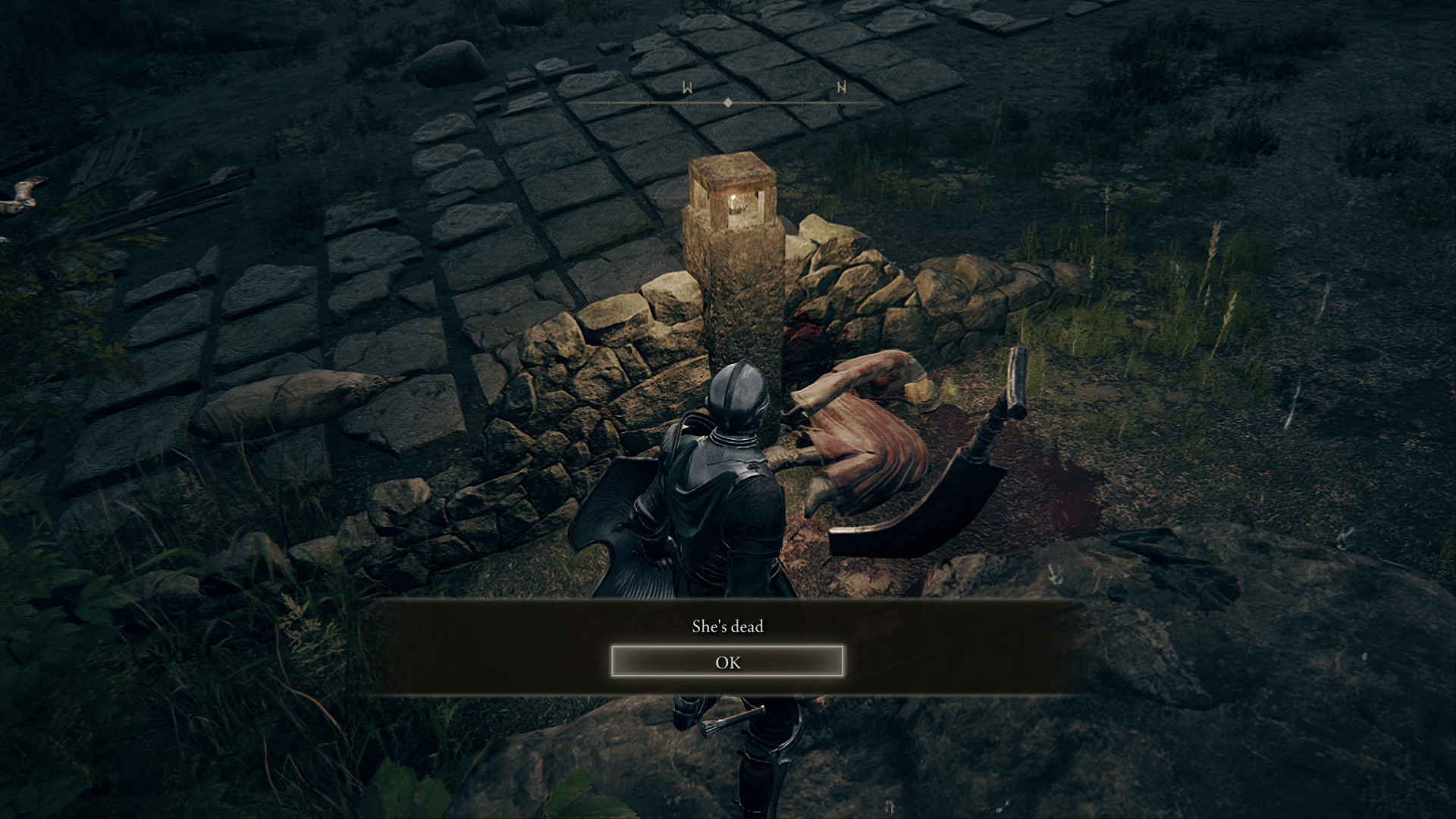 Dark fantasy game scene: armored warrior kneels beside a fallen woman near a glowing stone monument, with a somber “She’s dead” message.