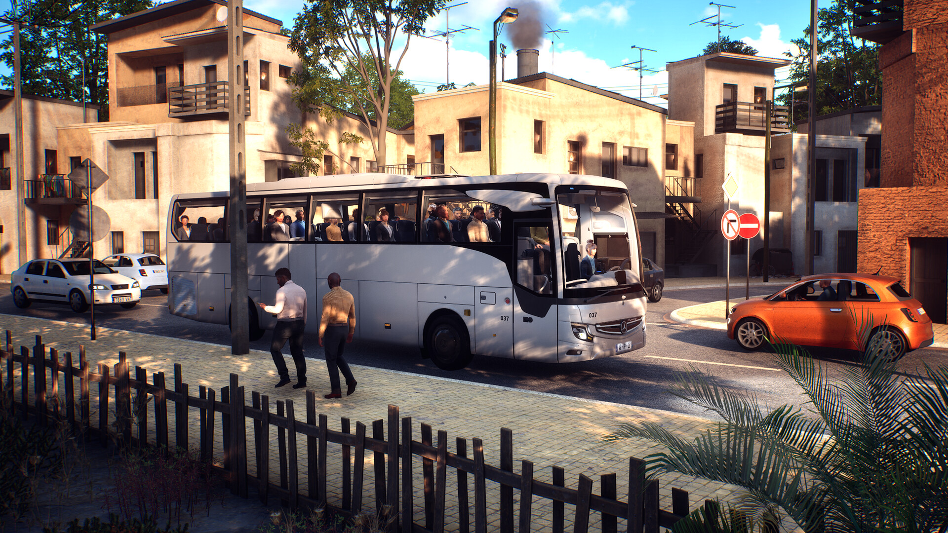 A coach full of passengers drives along a sun-soaked road.