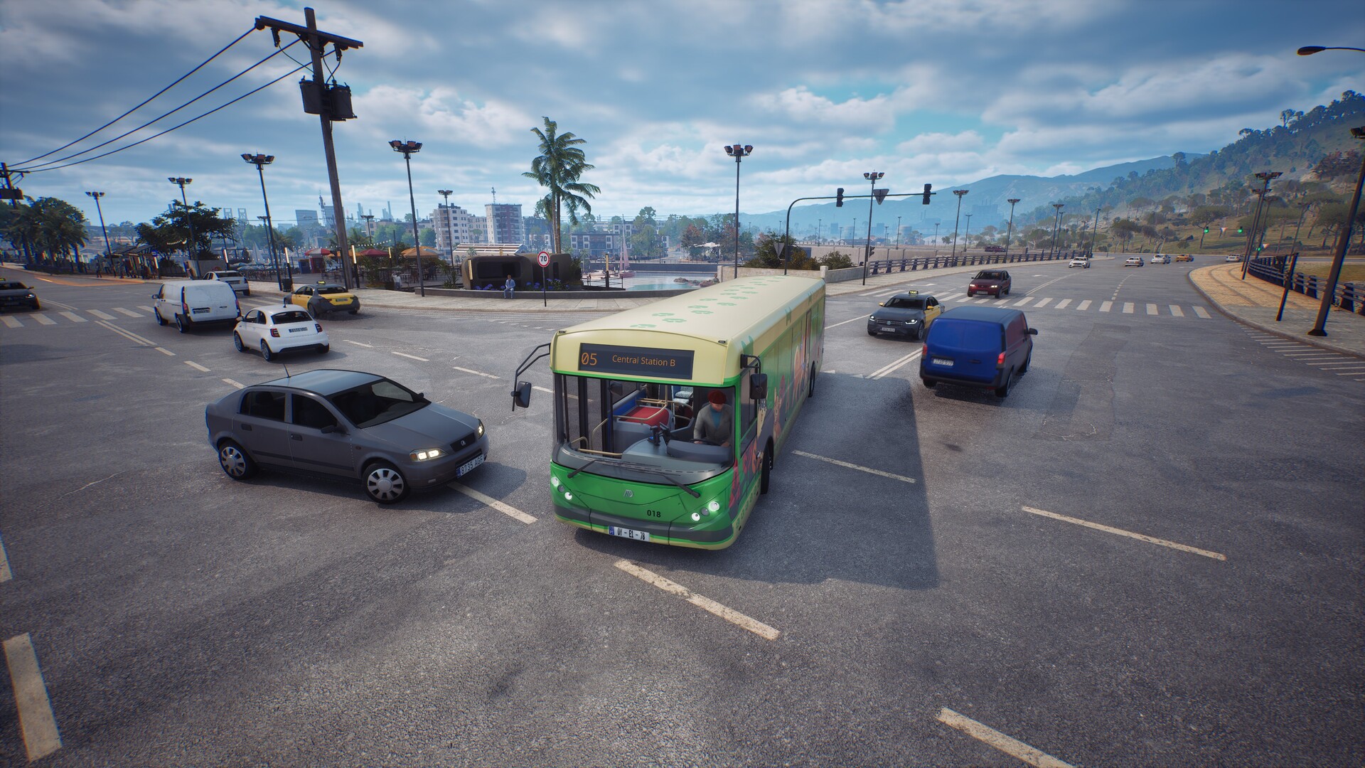 A green bus turning left onto a main road. An NPC car looks like it's about to crash into the side of it.