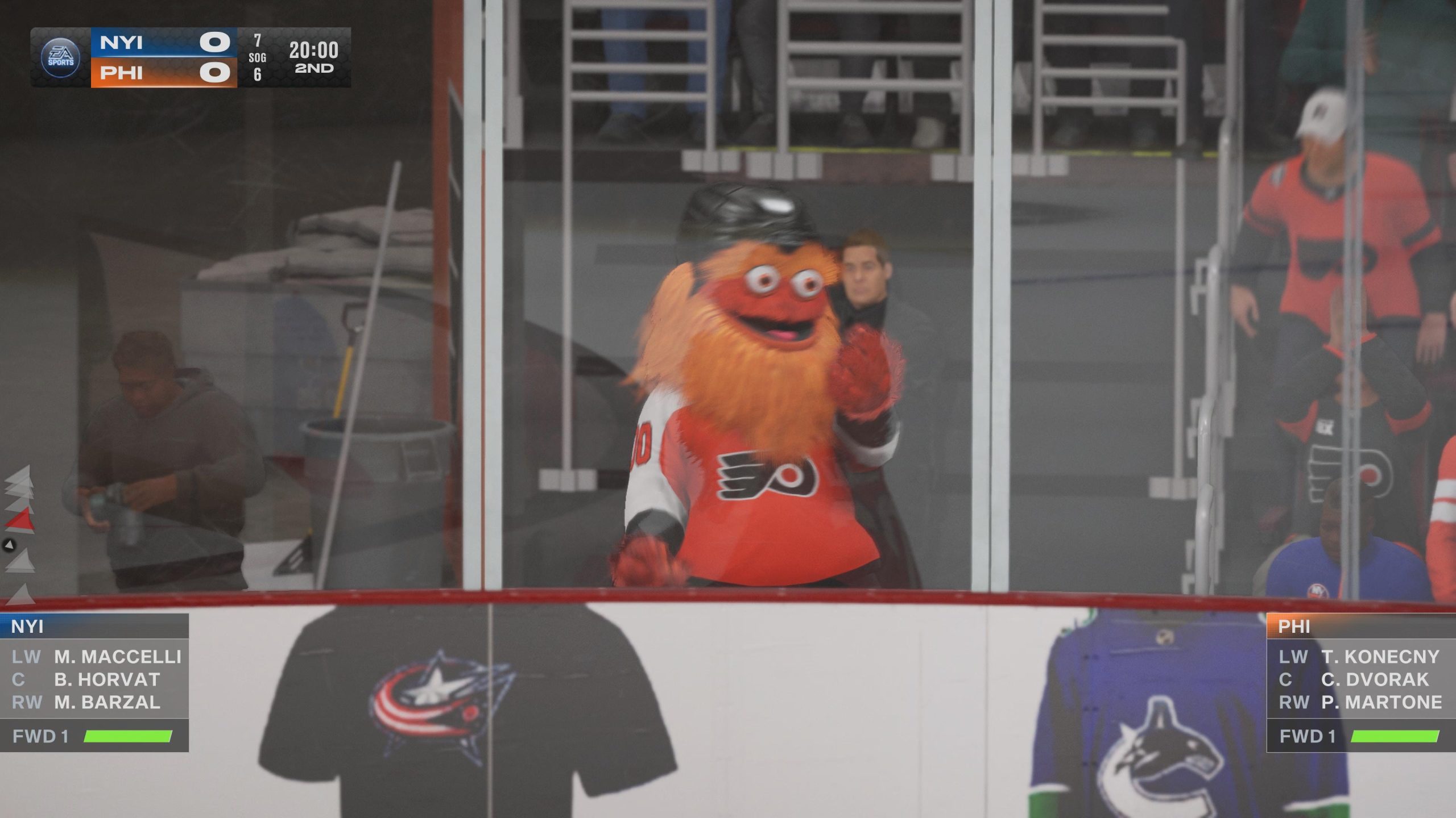 This image focuses on Gritty, the mascot for the Philadelphia Flyers NHL team. He is an orange monster, with big googly eyes. He is wearing a black helmet and the team jersey.