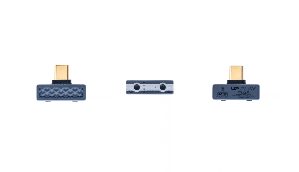 Centered on a white background, a small dark grey rectangular device, the iFi UP Play Max, has a textured zigzag face and a gold USB C connector protruding from its top. Views are from front, below and behind.