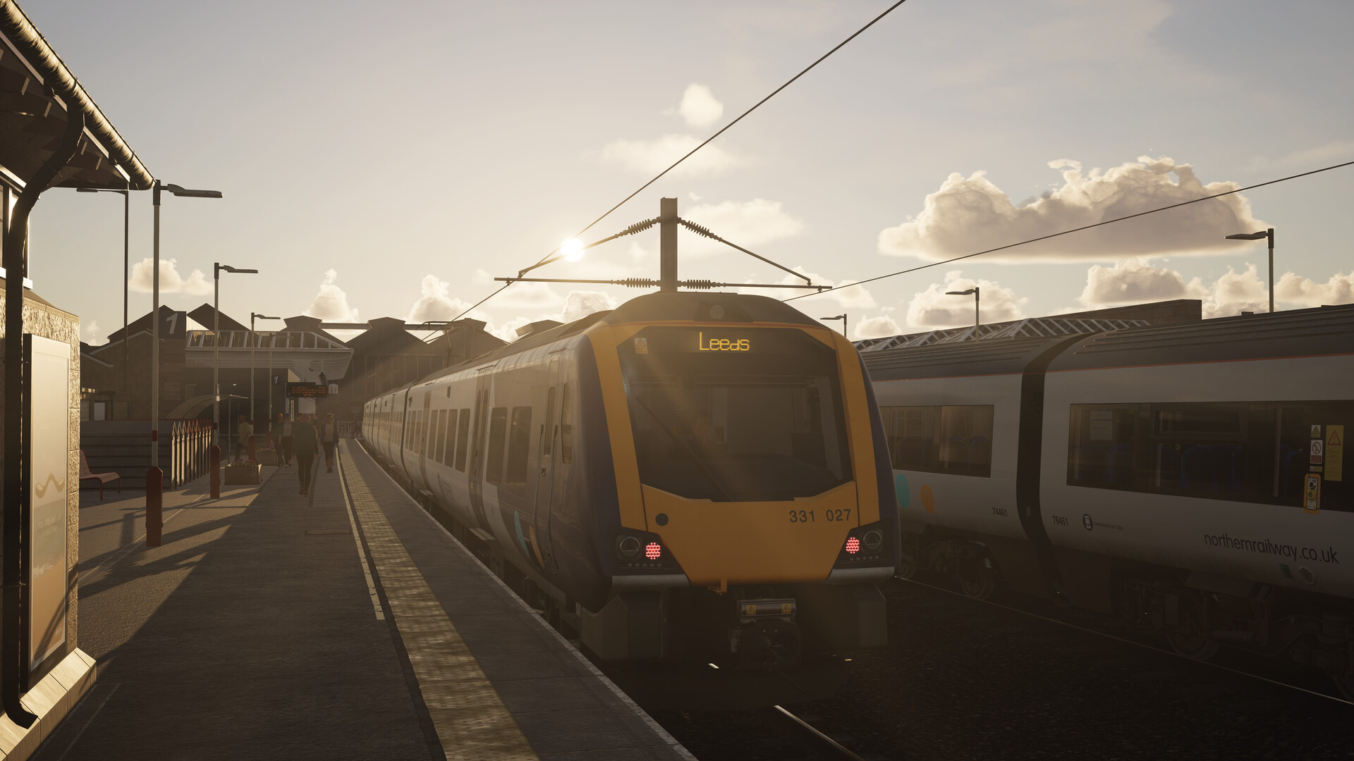 A train setting off, bound for Leeds. The sun is setting, casting an orange glow across the platform.