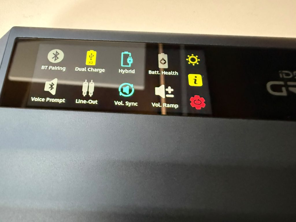 Close-up of the iFi iDSD GR 2 DAC with colourful icons for Bluetooth pairing, dual charge, battery health, voice prompt, and volume.