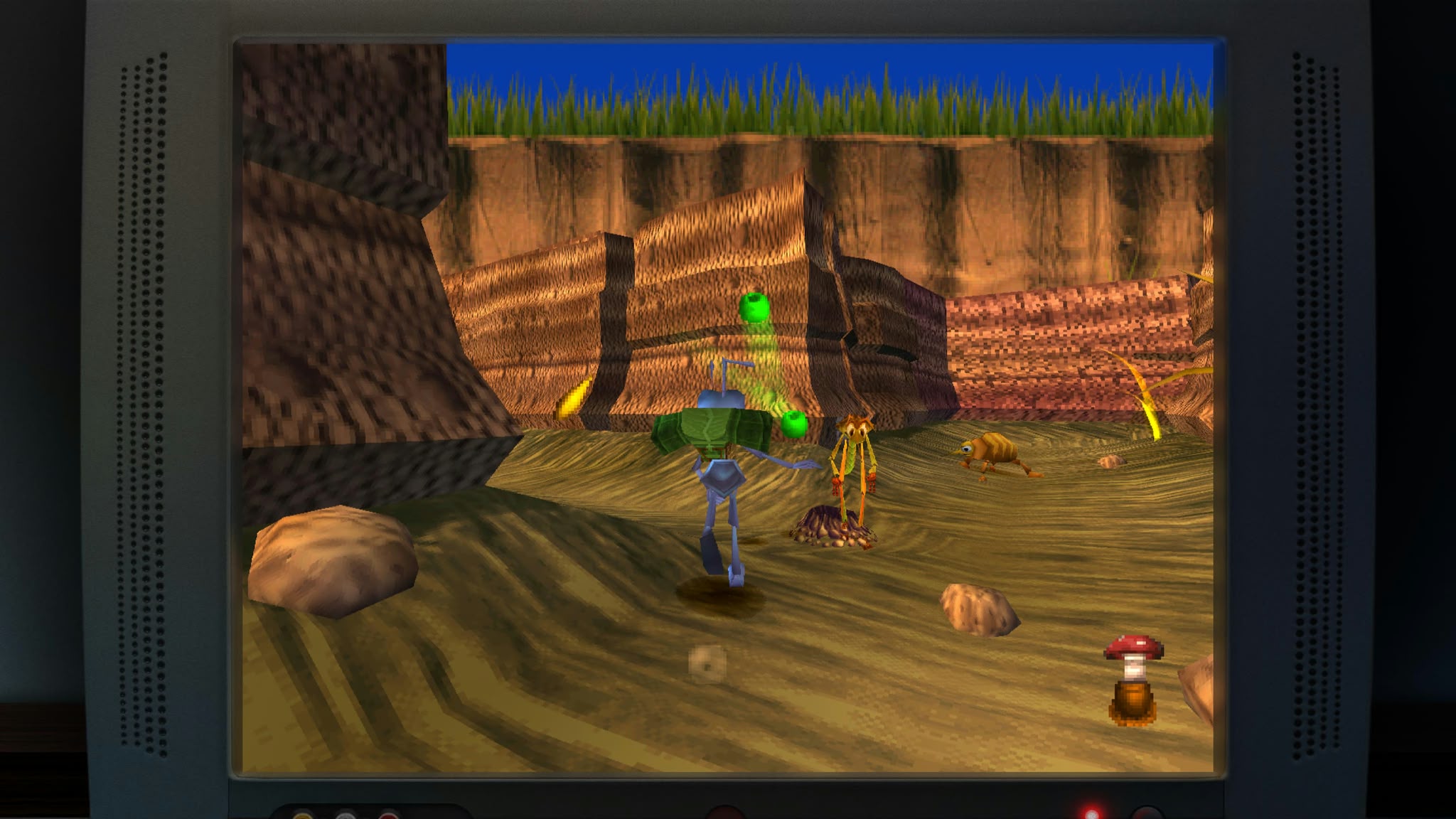A screenshot of the canyon level on A Bug's Life on a CRT screen, showing a Flik throwing projectiles at insect enemies.
