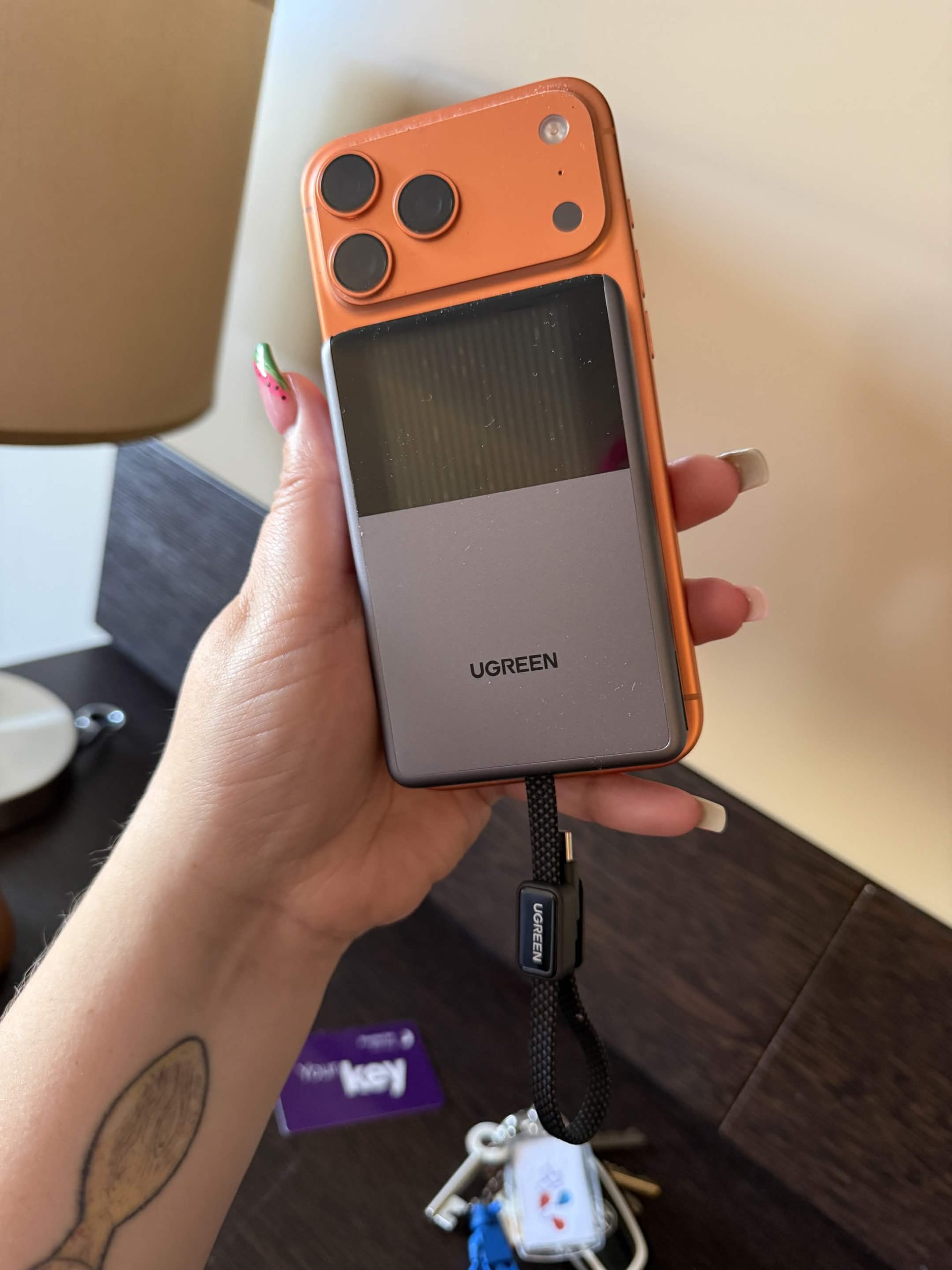 the magflow pro attached to a orange iphone